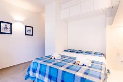 a bedroom with two stuffed animals on a bed at Sofia’s Studio at Mondello in Palermo
