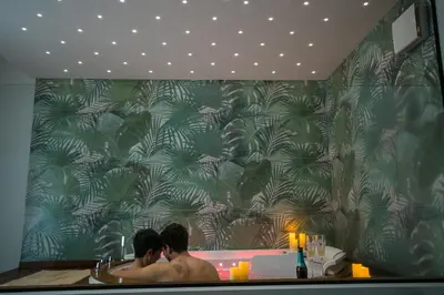 two men sitting in a bath tub in a bathroom at Maison La Lumia in Palermo
