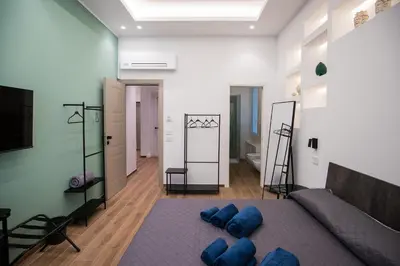 a living room with a couch and blue pillows on the floor at Maison La Lumia in Palermo