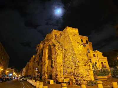 an old stone building at night with a moon at Terrazza Ballarò in Palermo