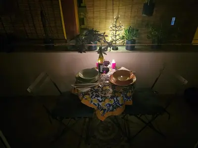 a table with two plates and a candle on it at Terrazza Ballarò in Palermo