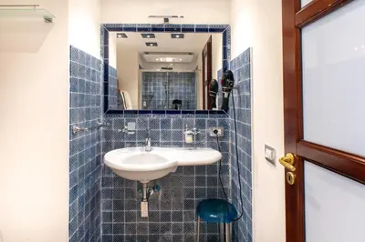 a bathroom with a sink and a mirror at Federico 70 Arabic Style in Palermo