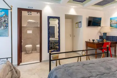 a bedroom with a bed and a bathroom with a toilet at Federico 70 Arabic Style in Palermo