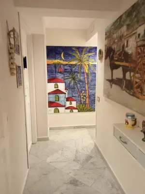 a hallway with a painting on the wall at Federico 70 Arabic Style in Palermo