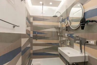 a bathroom with a sink and a mirror at Federico 70 Acquamarina Luxury in Palermo