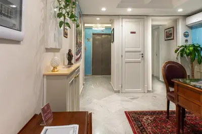 a hallway with a door and a table and chairs at Federico 70 Acquamarina Luxury in Palermo