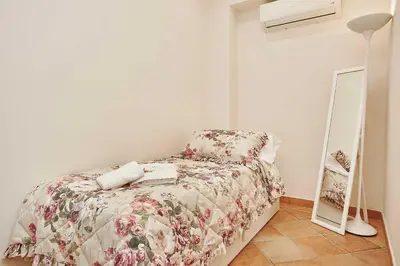 a bedroom with a bed and a mirror on the floor at Villa laura in Palermo