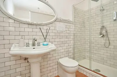 a bathroom with a sink and a toilet and a mirror at Villa laura in Palermo