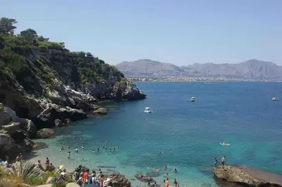 a group of people in the water at a beach at Relaxing seahouse in Santa Flavia