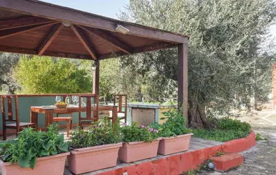 a wooden pavilion with a table and some plants at Lovely Home In Altavilla Milicia in Altavilla Milicia