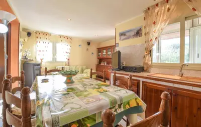 a kitchen with a table and a kitchen with a sink at Lovely Home In Altavilla Milicia in Altavilla Milicia