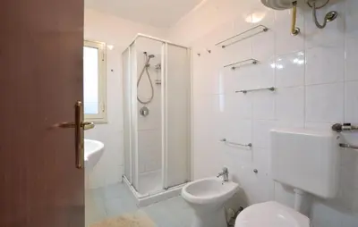 a bathroom with a toilet and a shower and a sink at Lovely Home In Altavilla Milicia in Altavilla Milicia