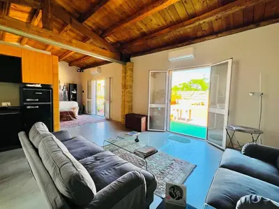 a living room with a couch and a table at Loft Palermo Centro con terrazzo. Free parking in Palermo