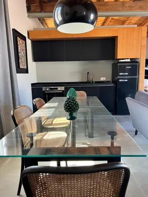 a dining room with a glass table and chairs at Loft Palermo Centro con terrazzo. Free parking in Palermo