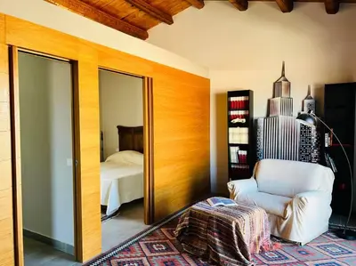 a room with a mirror and a chair and a bed at Loft Palermo Centro con terrazzo. Free parking in Palermo