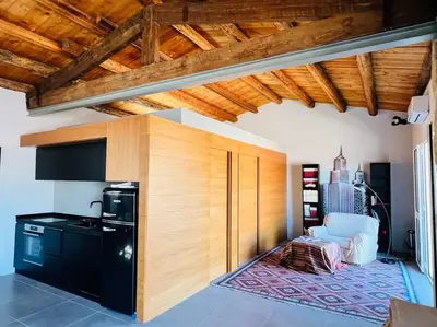a kitchen with a wooden wall and a stove at Loft Palermo Centro con terrazzo. Free parking in Palermo
