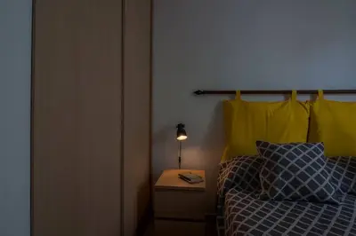 a bedroom with a bed and a side table with a lamp at Appartamento del centro CIR 19081005C217988 in Castellammare del Golfo