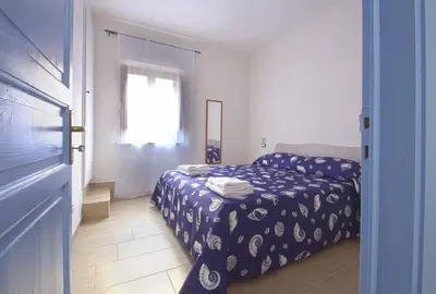 a hotel room with a bed and a window at Appartamento della macina CIR 19081005C212931 in Castellammare del Golfo