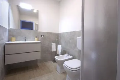 a bathroom with a toilet and a sink at Appartamento della macina CIR 19081005C212931 in Castellammare del Golfo
