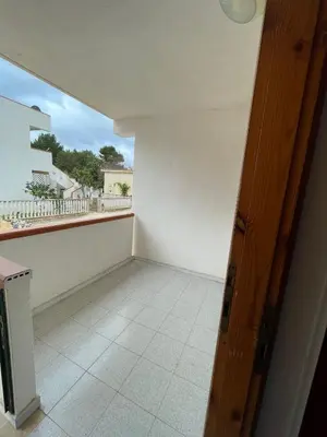 an empty room with a balcony with a window at Turisti a Casa in San Vito lo Capo