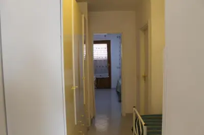 a hallway with a hallway leading to a room at Turisti a Casa in San Vito lo Capo