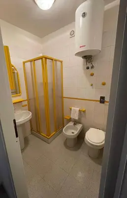 a bathroom with a toilet and a sink at Turisti a Casa in San Vito lo Capo
