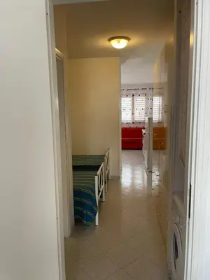 a hallway with a room with a bed in it at Turisti a Casa in San Vito lo Capo