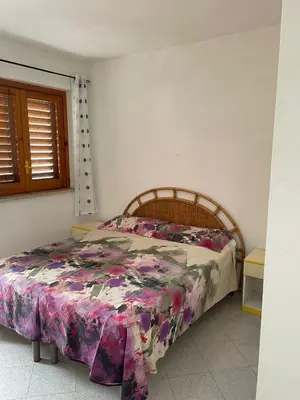 a bedroom with a bed in a room at Turisti a Casa in San Vito lo Capo