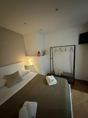 a bedroom with a large bed and a mirror at Quattro canti apartment Palermo centro storico in Palermo