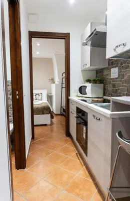 a kitchen with a door leading to a bedroom at Quattro canti apartment Palermo centro storico in Palermo