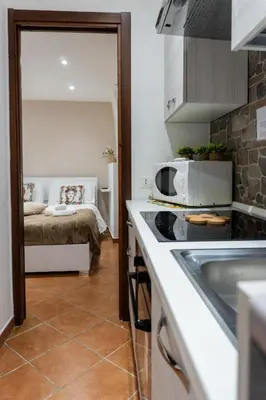 a small kitchen with a bed in a room at Quattro canti apartment Palermo centro storico in Palermo
