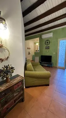 a living room with a couch and a table at Lilla' House Center Palermo in Palermo