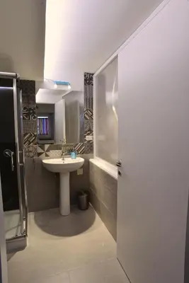 a bathroom with a sink and a shower and a tub at La Locanda dei Corrieri in Palermo