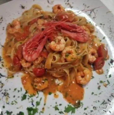 a plate of pasta with shrimp and sauce at casa giorgia mondello in Palermo