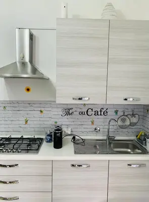a kitchen with a stove and a sign that reads the on cafe at casa giorgia mondello in Palermo