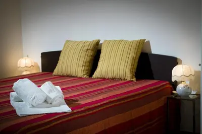 a bed with two towels and two pillows on it at Casa Vacanza Saraceno in Castellammare del Golfo