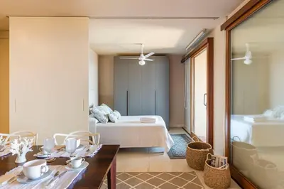 a room with a bed and a table and chairs at Casa del Rais con accesso privato al mare in Santa Flavia