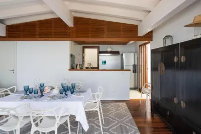 a dining room with a white table and chairs at Casa del Rais con accesso privato al mare in Santa Flavia