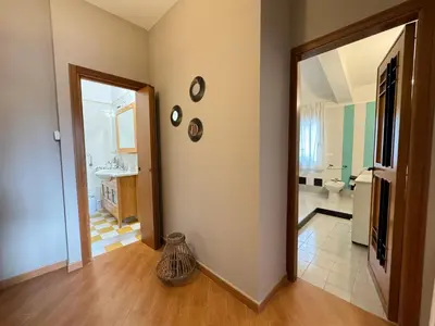 a room with a hallway with a mirror and a bathroom at Casa Lucale in Palermo