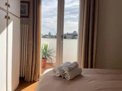 a room with two towels on a bed with a window at Casa Lucale in Palermo