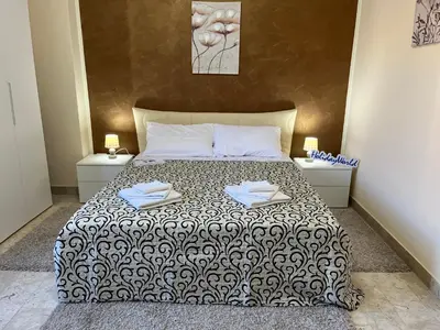 a bedroom with a bed with two towels on it at Sweet Home Pietro e Lia by Holiday World in Casteldaccia