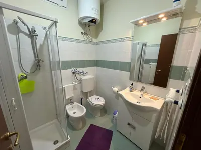 a bathroom with a sink and a toilet and a shower at Sweet Home Pietro e Lia by Holiday World in Casteldaccia