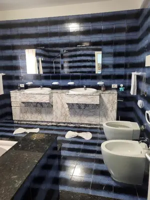 a bathroom with two sinks and two toilets at Sole nascente in Terrasini