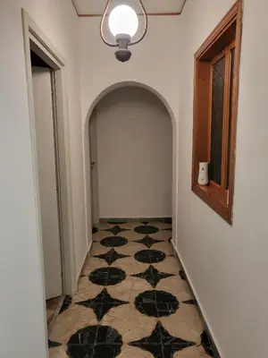 a hallway with a black and white tile floor at Sole nascente in Terrasini
