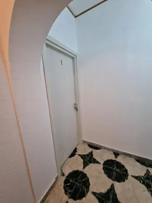 a hallway with a door and a tile floor at Sole nascente in Terrasini