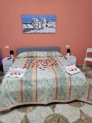 a bedroom with a bed with a quilt on it at Sole nascente in Terrasini