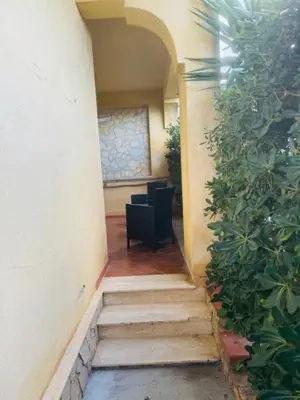 a hallway with a table and a chair in a building at L'abete in Villabate