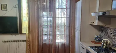 a kitchen with a transparent curtain in a kitchen at L'abete in Villabate