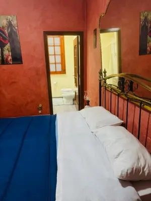 a bedroom with a bed in a room with red walls at L'abete in Villabate