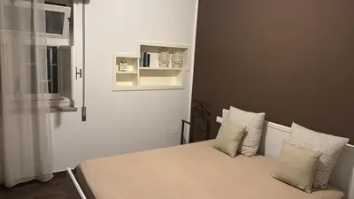 a bedroom with a bed with two pillows on it at Marina Mondello House comfort in Mondello